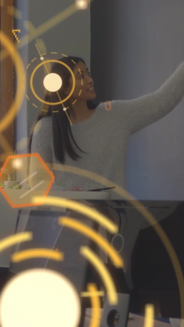 Vertical video: Office pro checking phone then gesturing to screen while amber HUD overlay shifting