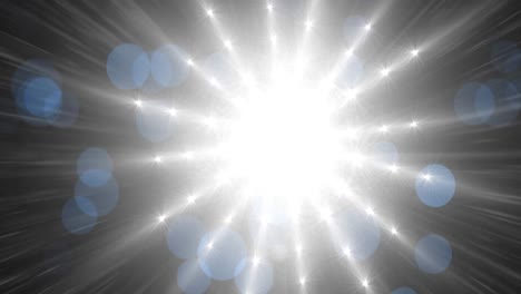 digital animation of blue bokeh spots of light over bright spot of light against black background