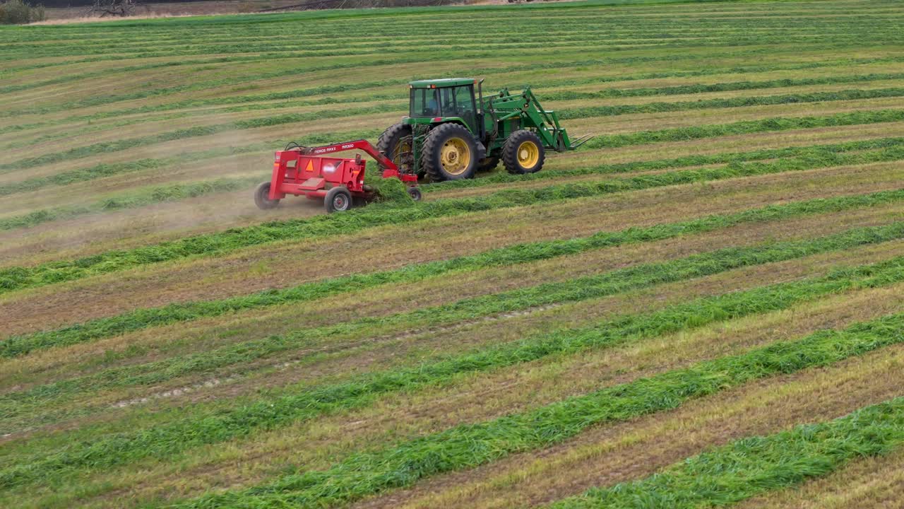 Harvest Time Beauty: Tedding, Raking, and a Green Tractor at Work in British Columbia's Circular Fields