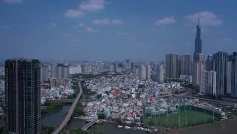 ho chi minh city, saigon river and binh thanh skyline panorama on sunny, clear day featuring landmark building from drone orbit shot