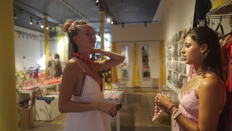 two women trying on jewelry in a store