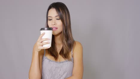 smiling confident young woman drinking coffee