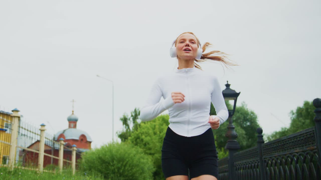 Woman running with headphones outdoors