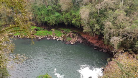 serene river and rocky cave scene at gruta india natural park, argentina