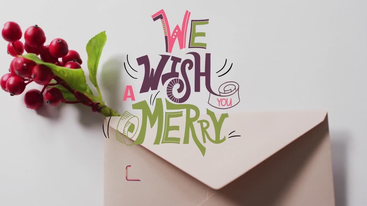 Animation of merry christmas text banner over red berries and envelope on grey surface