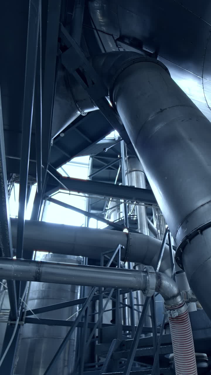 Diary food industry milk production. New technological milk factory with steel tubes. Vertical video