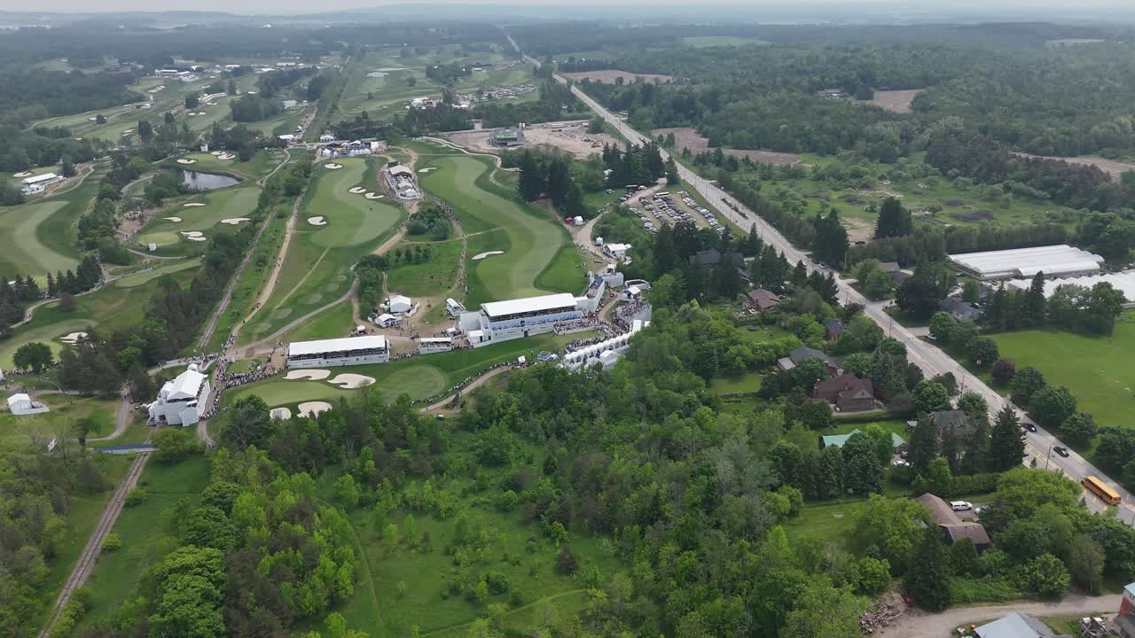 Drone establishing orbit of golf fairway and players during RBC Canadian Open in Caledon, Ontario, Canada