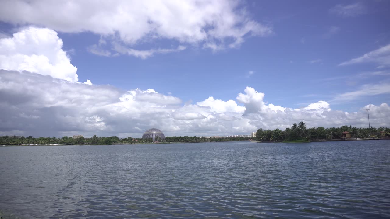 Landscape of lake, city and cloudy sky.