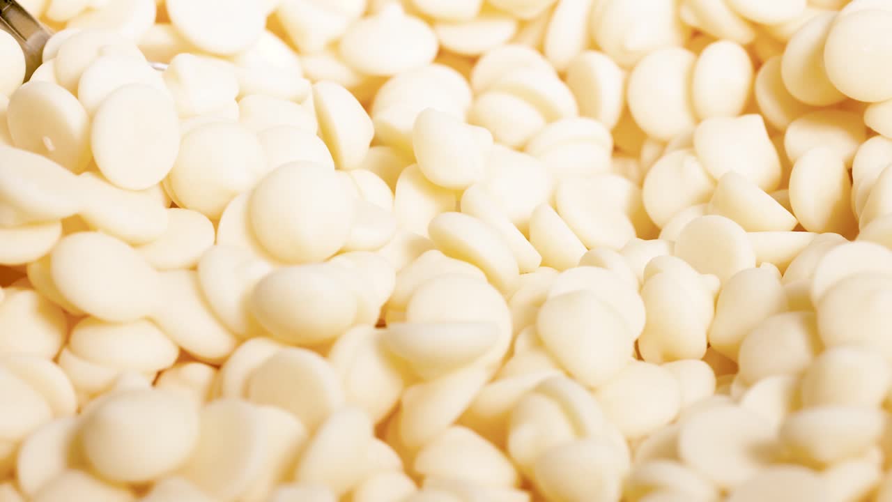 Spoon scooping white chocolate chips repeatedly