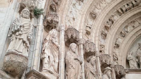 apostles sculptures, archivolt and tympanum at the entrance of santa maria basilica in castello d'empuries in girona, catalonia, spain