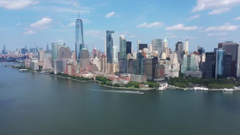 a bird's eye view over upper bay with water vessels moving by the bottom of manhattan island