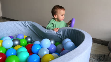 baby playing in a ball pit and exploring stairs