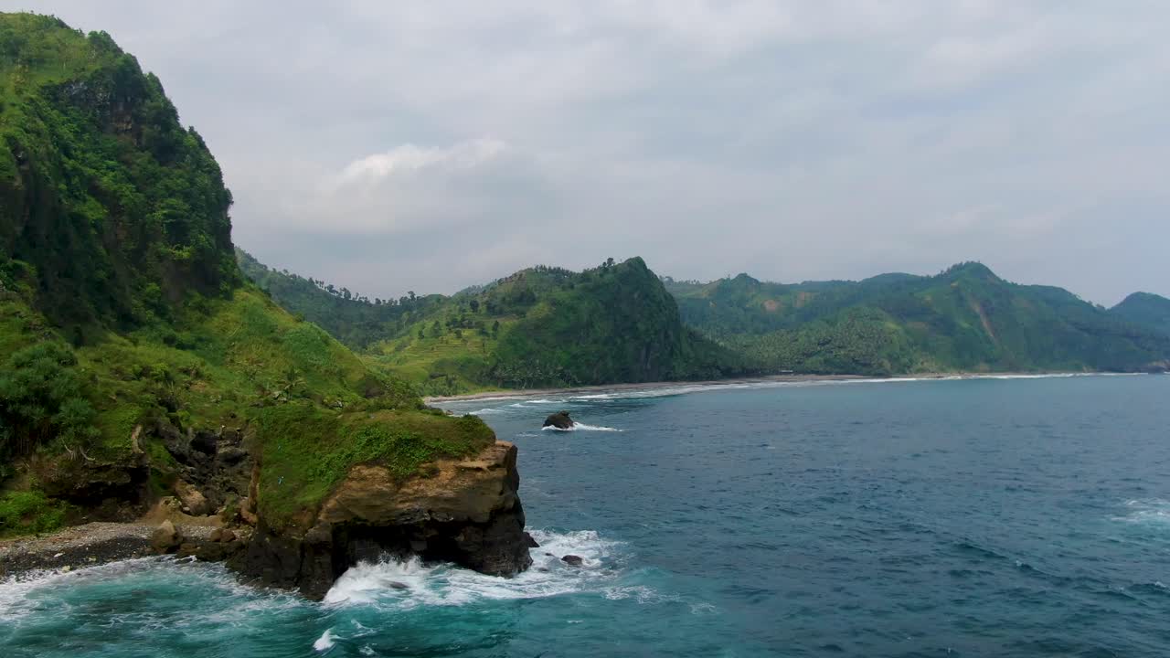 Cliffs by tropical paradise Menganti beach, Java, Indonesia, aerial view
