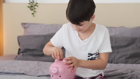 niño insertando moneda en la alcancía