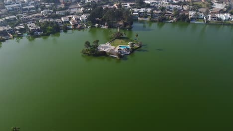 drone video of a lake with a small island in the middle