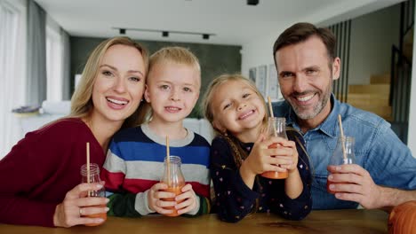 portrait of happy family with smoothie