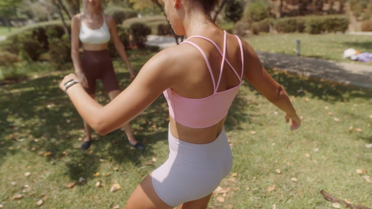 Two women playing soccer in the park