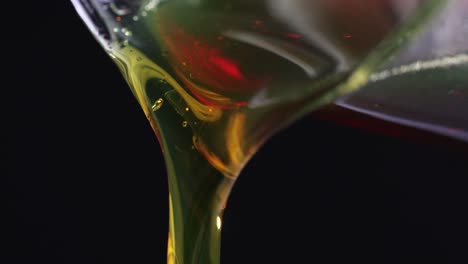 close-up of golden viscous liquid being poured