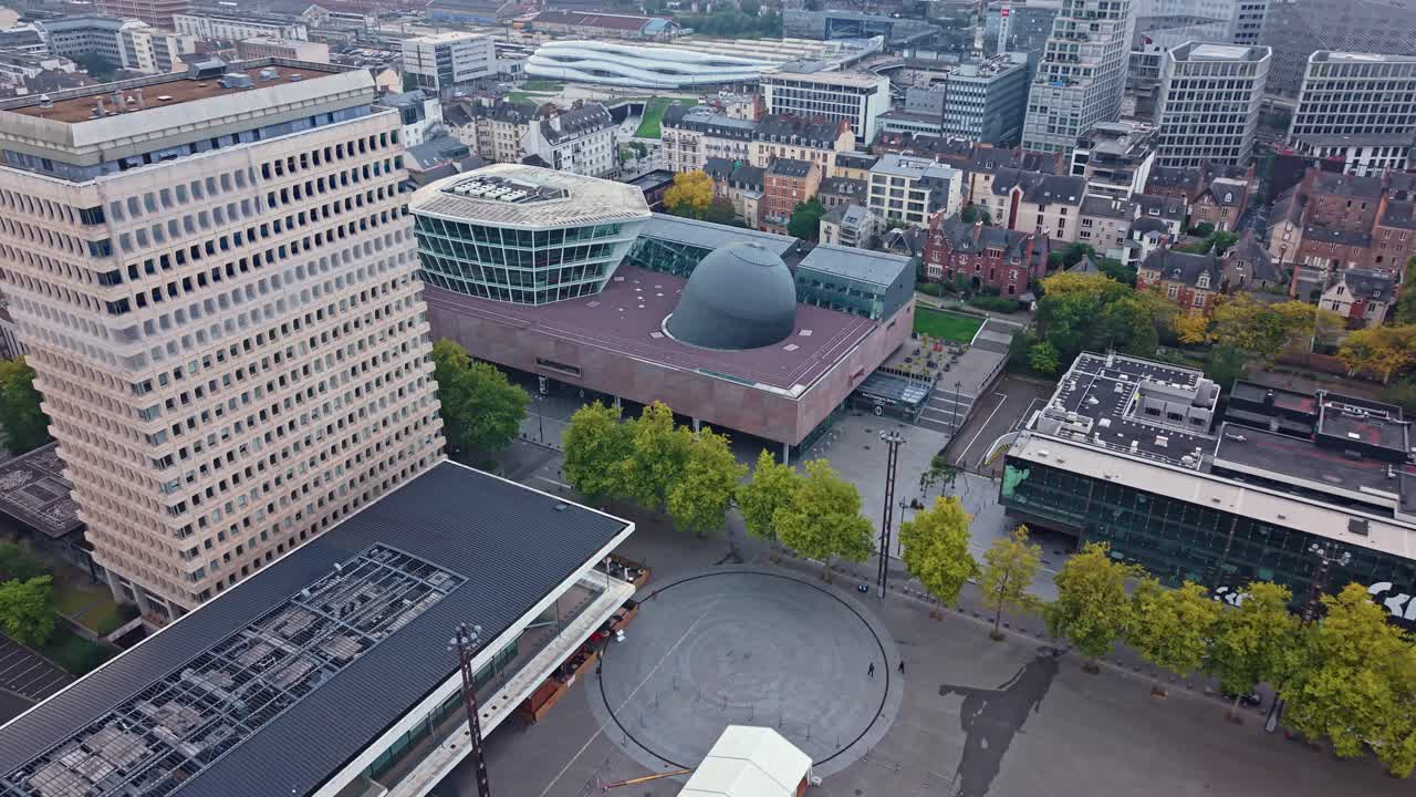 Les Champs Libres cultural center in Rennes, France, modern architecture, planetarium, and surrounding cityscape. Aerial drone circling