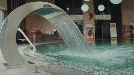 water streaming in swimming spa pool. hydromassage waterfall jet in swim spa.