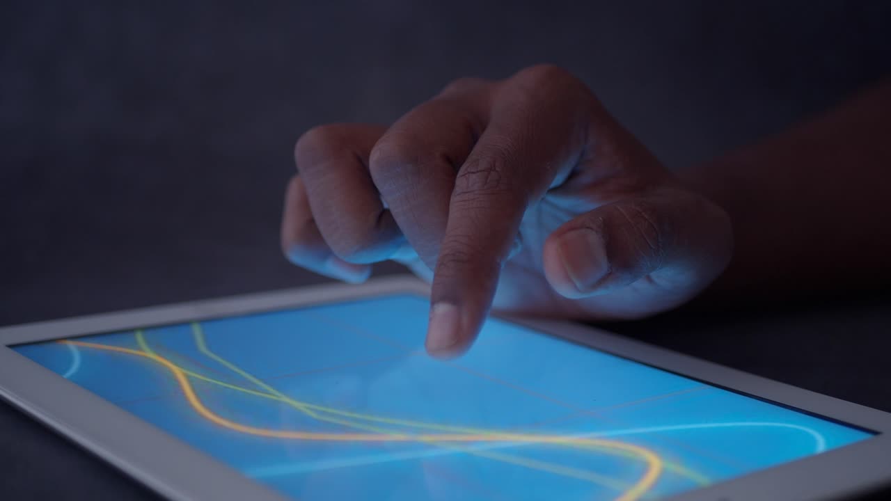 Hand interacting with data on a tablet