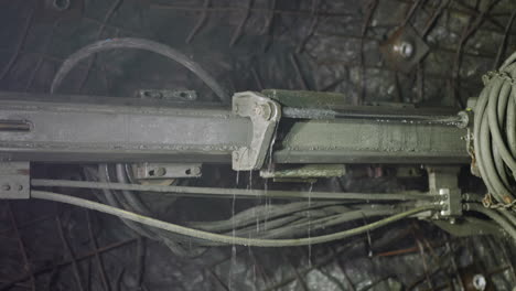 robot drill with pipes and coolant operates in ore mine