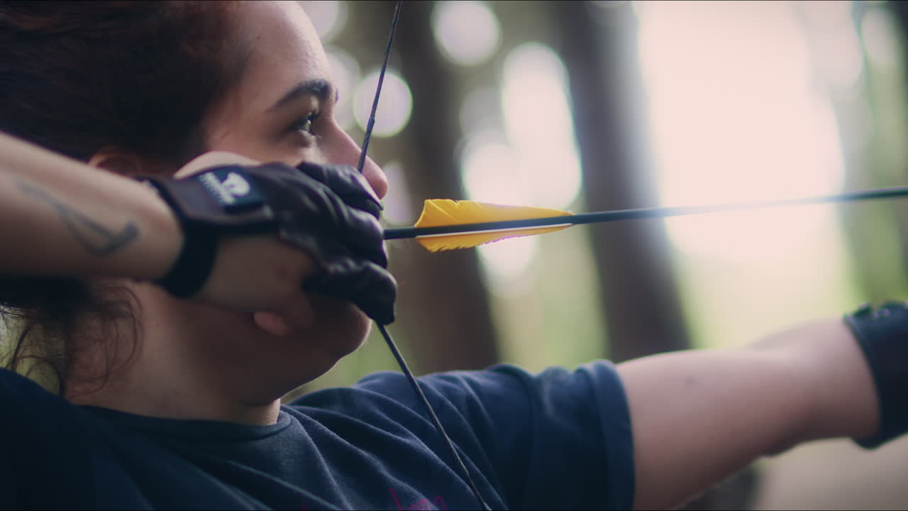 Archery woman holds her bow close up shot