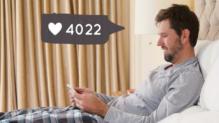 Man lying in bed while checking his phone 4k