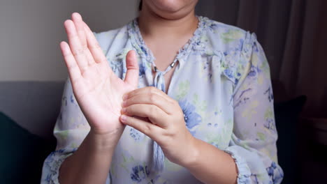 women doing hands stretching and exercising to protect office syndrome and hand arthritis after work at home office day