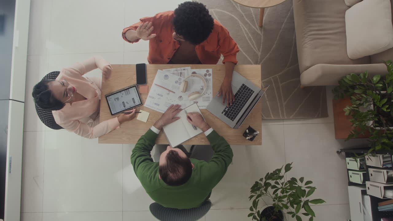 Top Down of Business Colleagues Having Meeting at Table