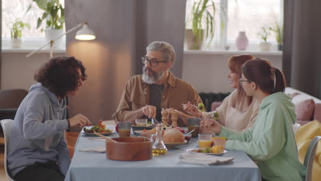 happy family eating dinner and having discussion at home