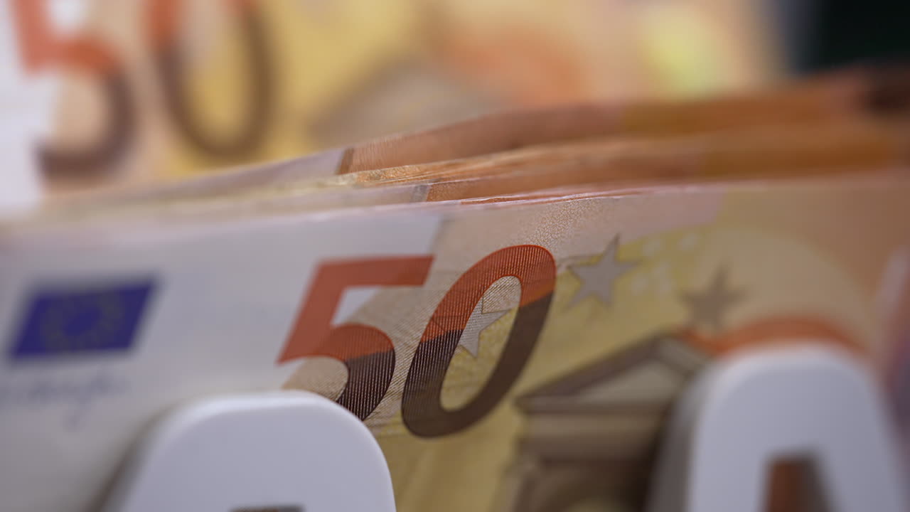 Close up of euro banknotes while counting. Financial money currency counting machine.
