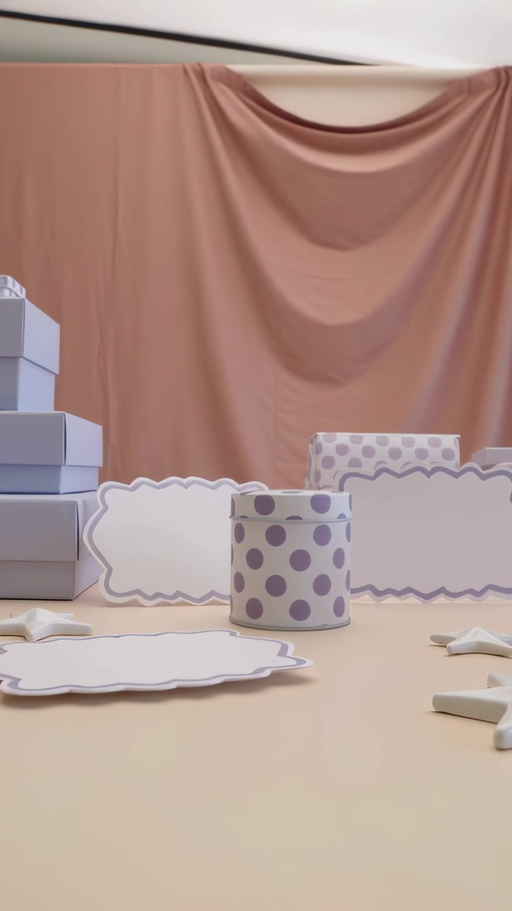 Vertical video: Pulling back cam revealing polka-dot tin on table with boxes, stars to show display