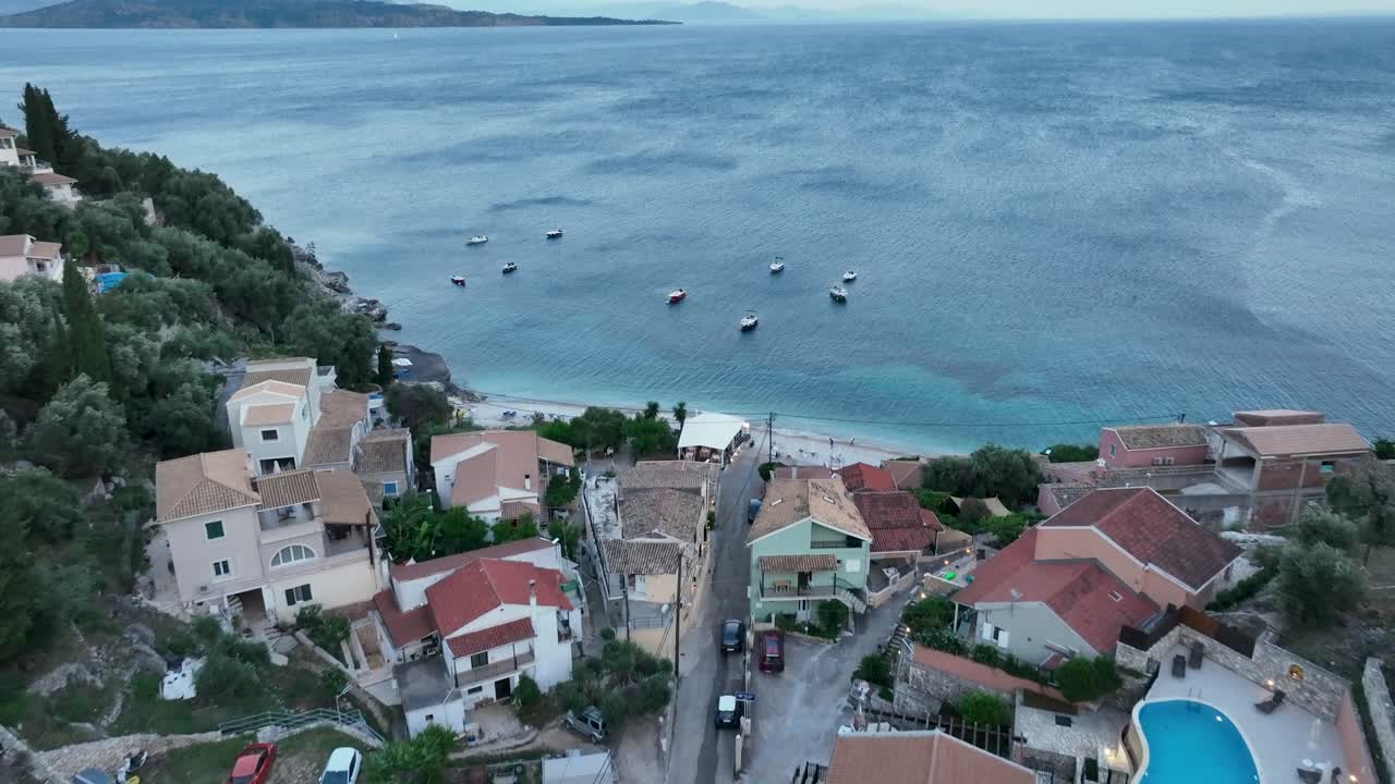 Greek Island Evening: Kaminaki Village and Beach Under the Twilight Sky – A Cozy and Inviting Scene on the Coast of Corfu
