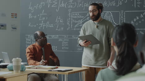 professor lecturing in a university classroom with students