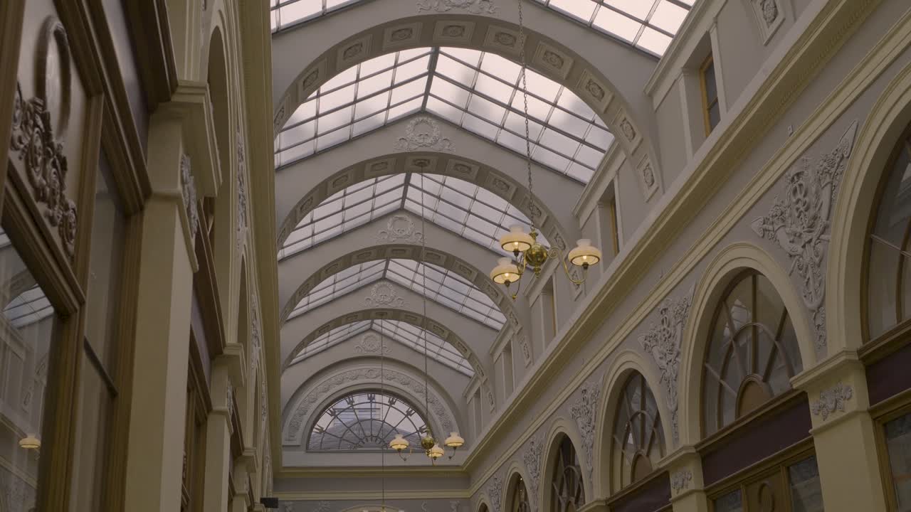 Classic Parisian glass-covered arcade with elegant architectural details and lighting
