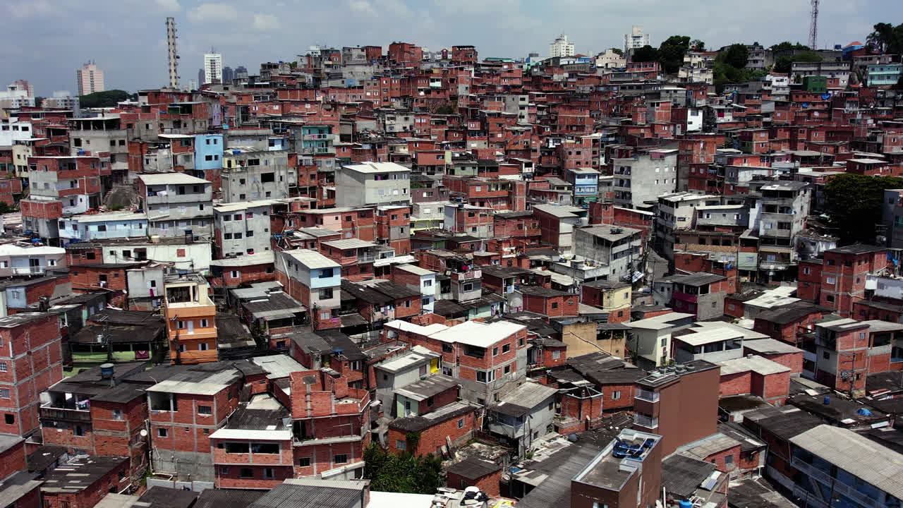 Aerial view in front of old shacks, poor community living in sunny South America