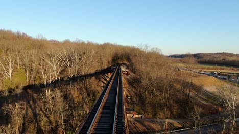 Aerial Shot Pushing Forward Along the Pope Lick Railroad Trestle in Louisville Kentucky During the Sunset