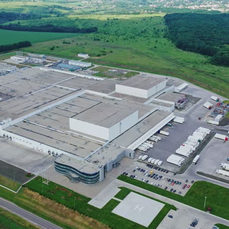 large territory of industrial complex. modern manufacturing on green natural environment. panoramic view of huge factory among nature. aerial view.