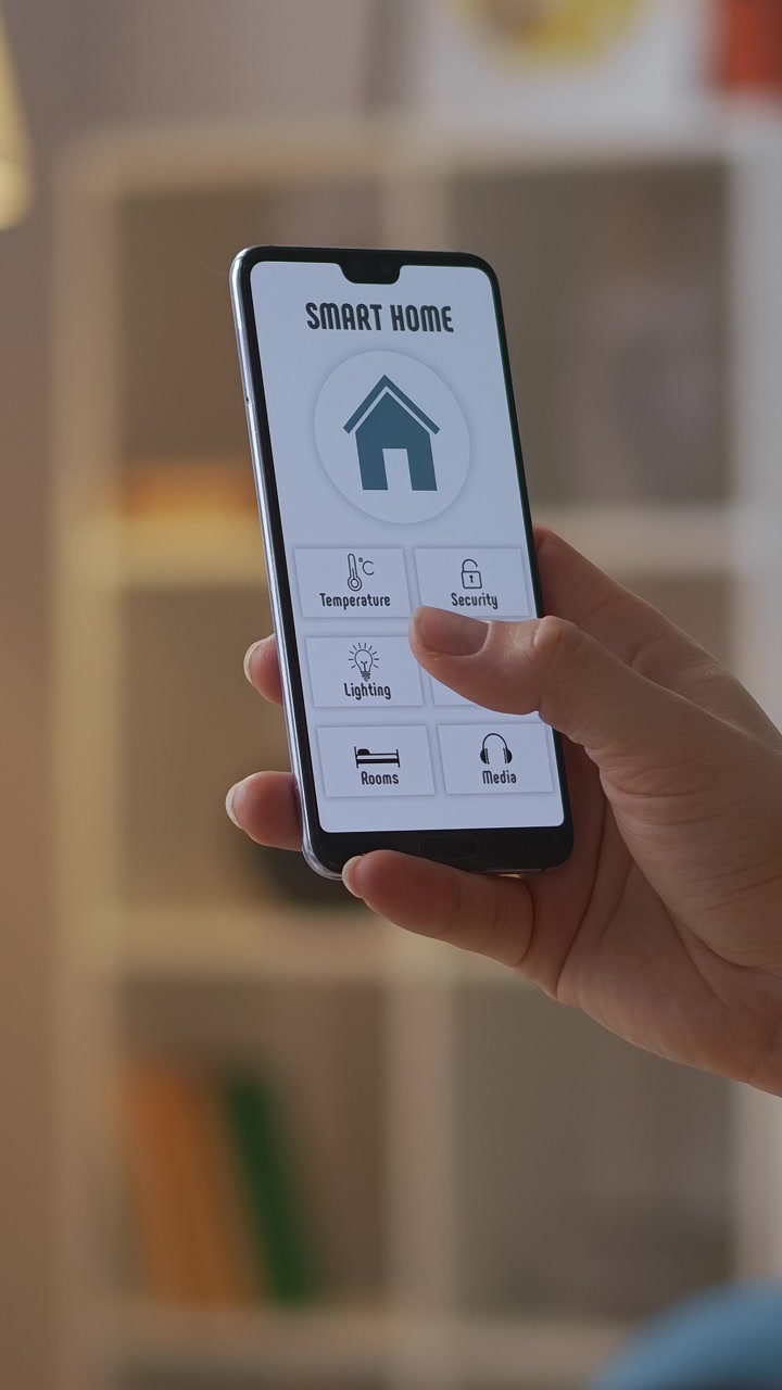 Hand Adjusting Smart Home Temperature and Security Settings on Smartphone