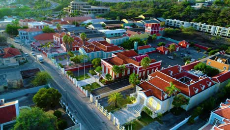 homes and official buildings in willemstad curacao illuminated by sunrise golden hour