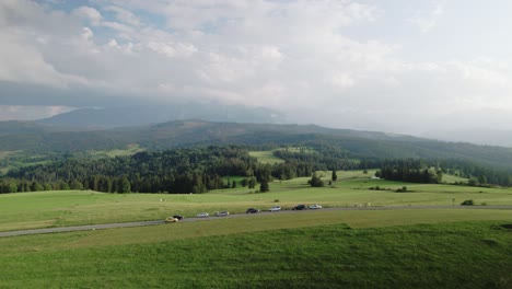 4k drone shot of polish tatra mountains landscape and green fields on cloudy day