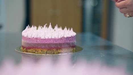 close view girl finishes to decorate delicious pink cake