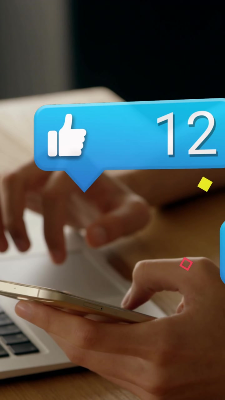 Animation of social media icons falling over person using laptop