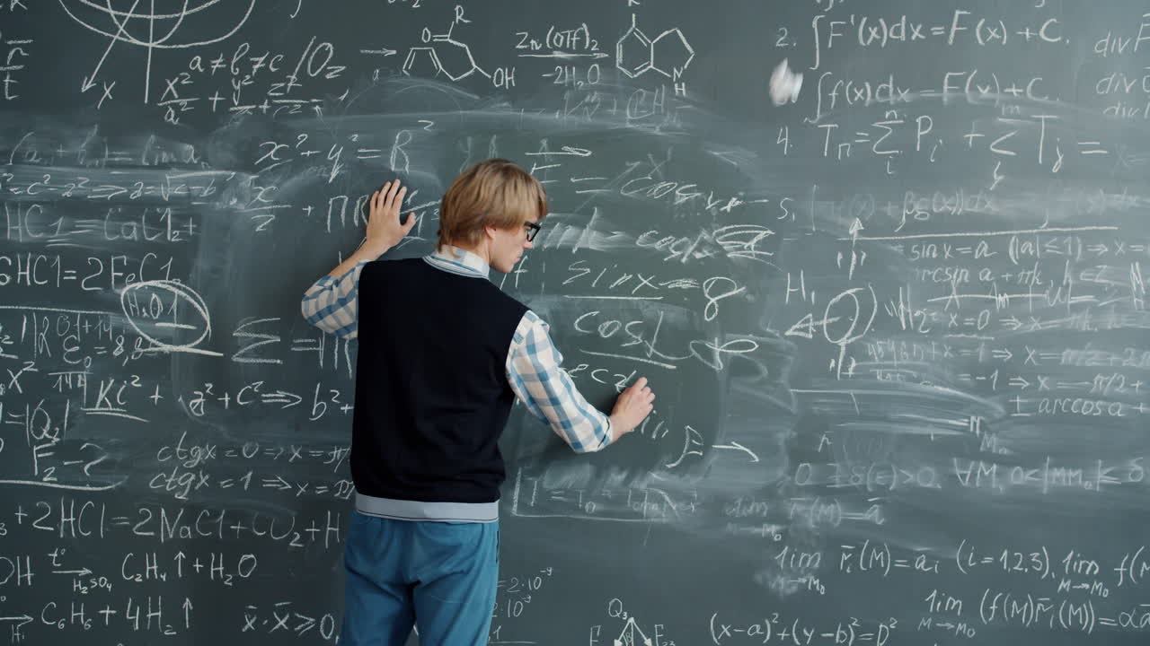 Student Juggling Balls in Front of a Blackboard Covered in Equations