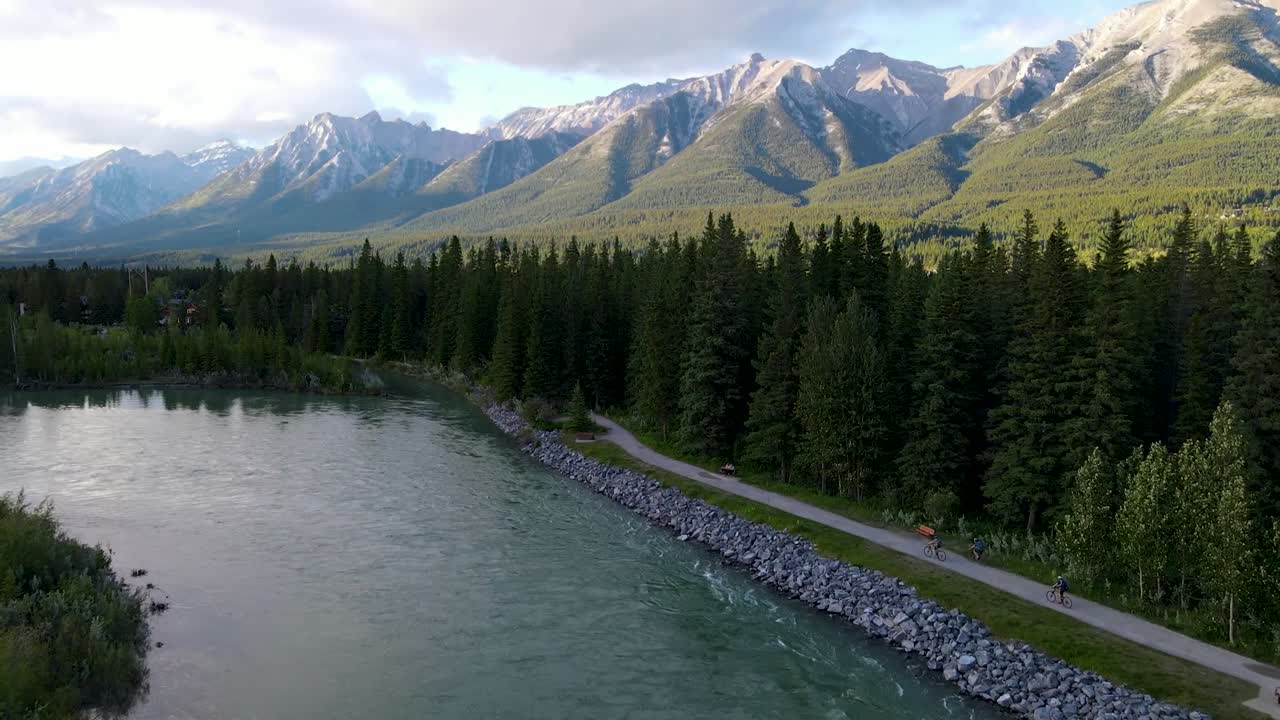 Drone following creek toward mountains summer
