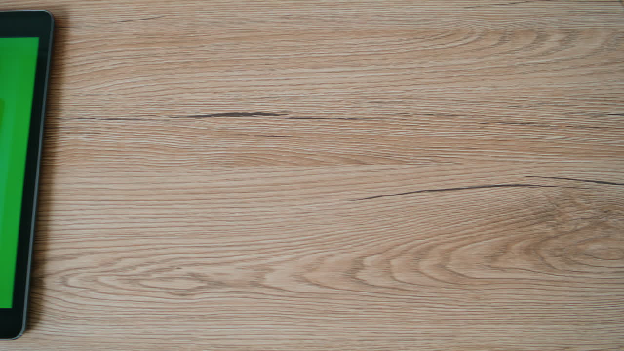 Finger touching chroma key tablet lying office desk closeup. Unknown person