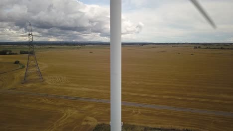 aerial pedestal shot of wind turbine in operation