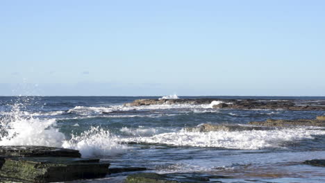 Olas-Llenas-De-Arena-Rompiendo-En-Las-Rocas-Del-Océano-Frente-A-La-Pantalla-En-Cámara-Lenta-Turimetta-Beach-Sydney-Australia