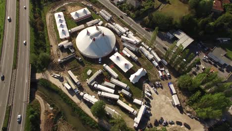 Travelling-Circus-on-Road-in-Small-Village-Aerial-View